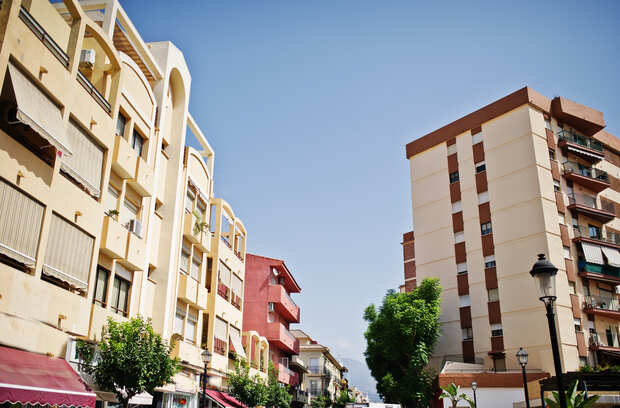 Residential buildings on a street in Alicante under a clear sky