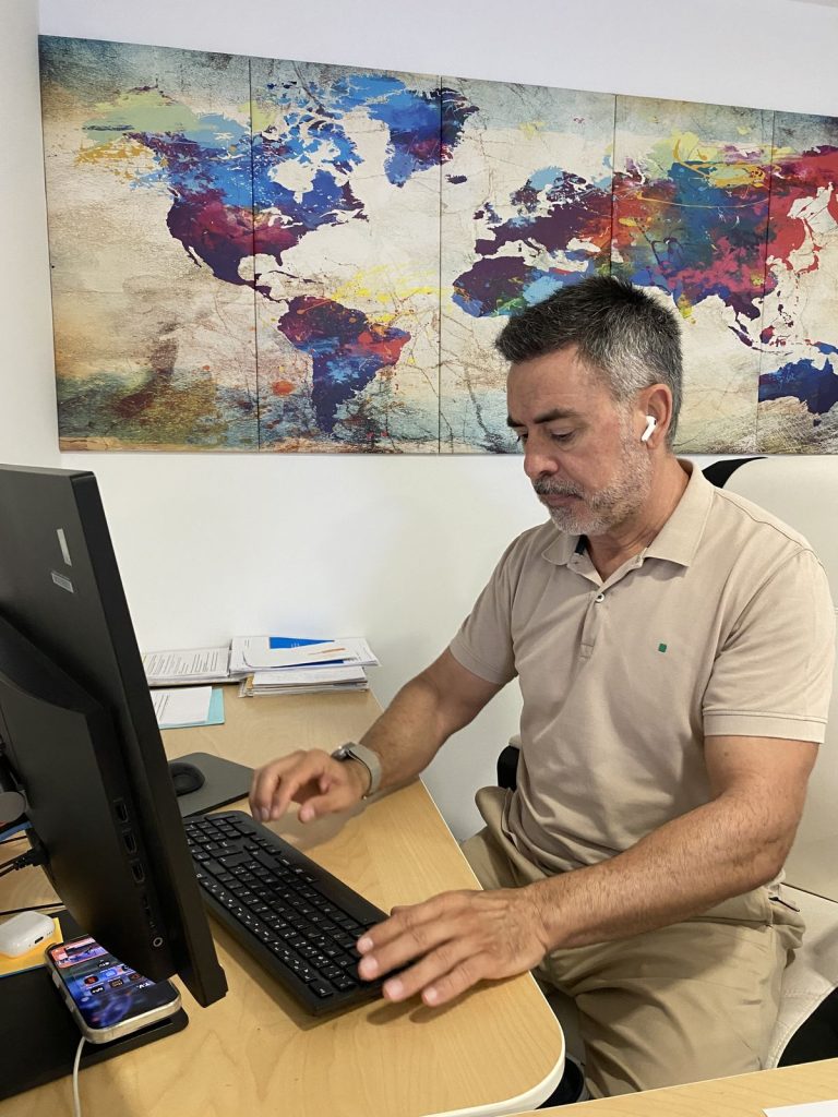 Wereal agent reviewing a case on his computer in Alicante