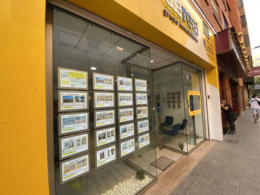 Wereal agency shop window with listings of homes for sale in Alicante