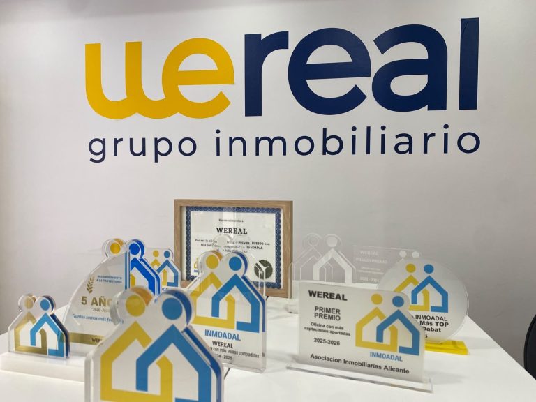 INMOADAL trophies and awards of Wereal Grupo Inmobiliario on the office table in Alicante